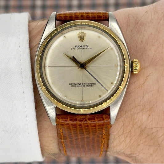 Vintage Rolex watch with brown leather strap on wrist